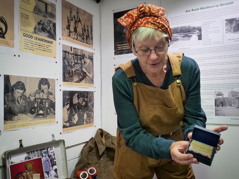 A Bexhill Museum Education Team volunteer with the WWI collection.